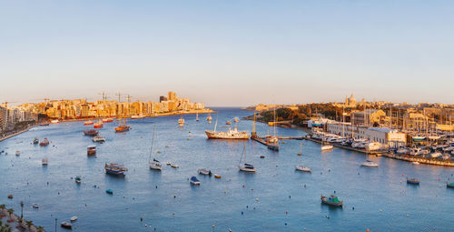 High angle view of townscape by sea against clear sky