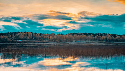 Scenic view of lake against sky during sunset