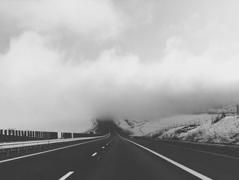 Empty road against sky during winter