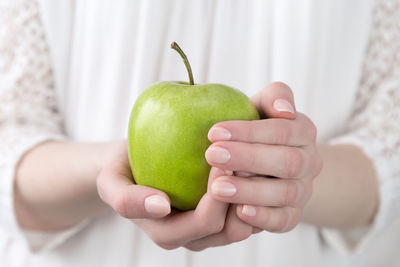 Close-up of woman holding apple