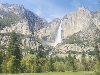 Scenic view of waterfall against sky