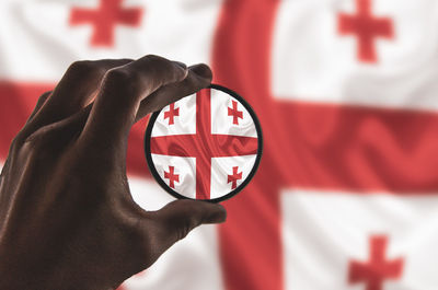 Close-up of hand holding flag