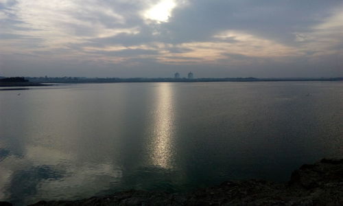 Scenic view of sea against cloudy sky