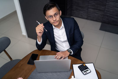 Businessman working at desk in office cafeteria