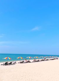 Scenic view of beach against blue sky