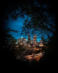 Low angle view of city lit up at night