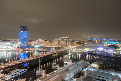 Illuminated cityscape against sky at night