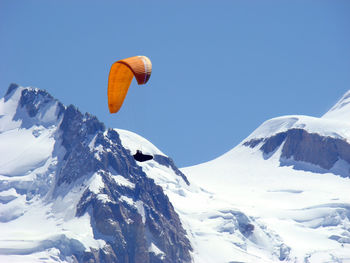 Low angle view of snow capped mountain against sky