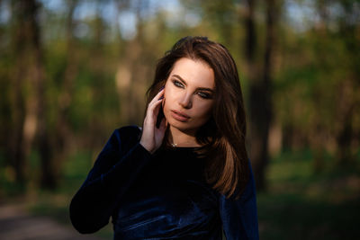 Portrait of beautiful young woman standing outdoors