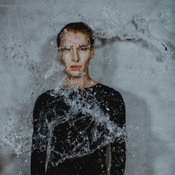 Portrait of woman standing in rain