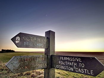 Road sign against sky