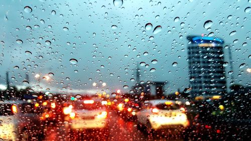 View of city seen through wet window