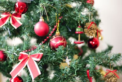 Close-up of christmas decorations hanging on tree