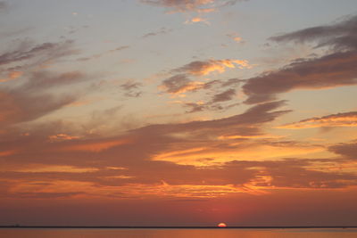 Scenic view of sea against orange sky