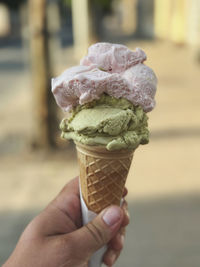 Cropped hand holding ice cream cone