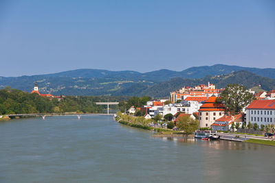 River amidst buildings against clear sky