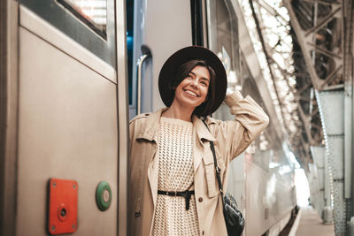 Portrait of smiling young woman using phone