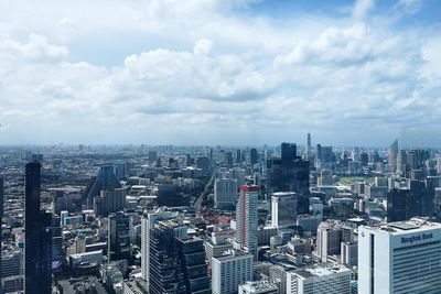 High angle view of modern buildings in city against sky