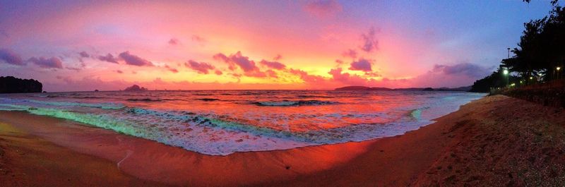 Panoramic view of calm beach at sunset