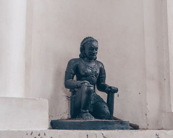 Close-up of statue against wall against building