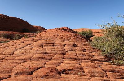 Low angle landscape of sloping orange rock formation in snow canyon state park in utah