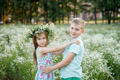 Portrait of smiling girl standing against plants