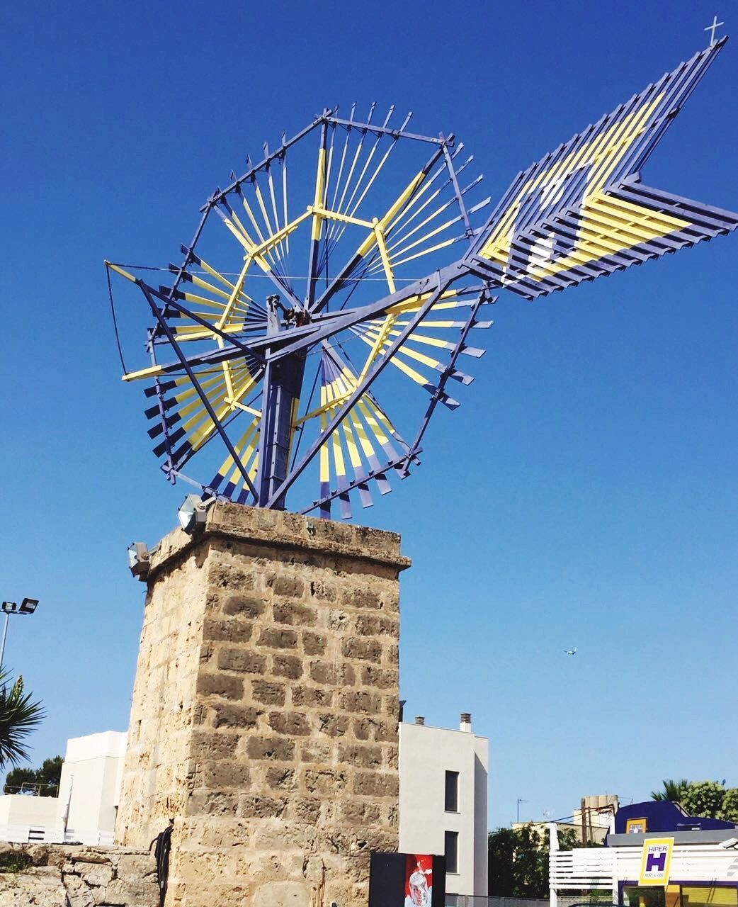 LOW ANGLE VIEW OF TRADITIONAL WINDMILL AGAINST SKY