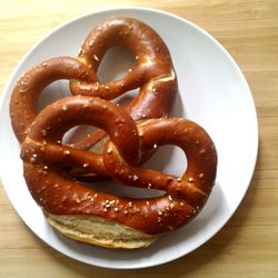 High angle view of pretzel breads on wooden table