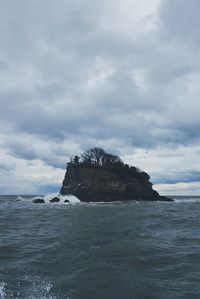 Scenic view of sea against cloudy sky