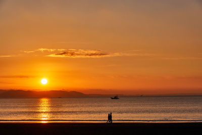 Scenic view of sea against orange sky