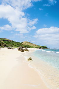 Beautiful view of beach against cloudy sky