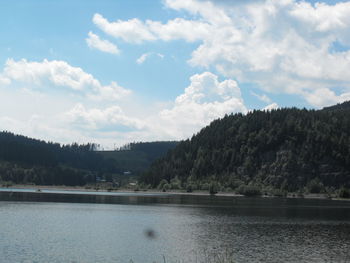 Scenic view of lake against cloudy sky