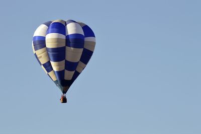 Hot air balloon flying against clear sky