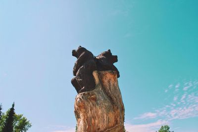 Low angle view of statue against clear blue sky