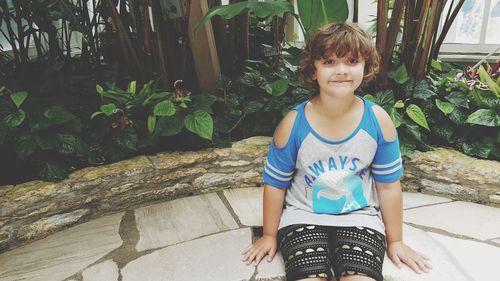 Portrait of boy sitting outdoors