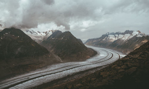 Road amidst mountains against sky