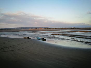 Scenic view of beach against sky during sunset