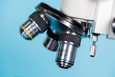 Close-up of microscope on blue background
