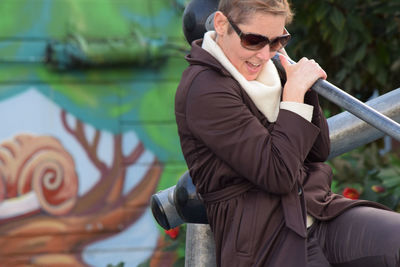 Close-up of woman standing on railing