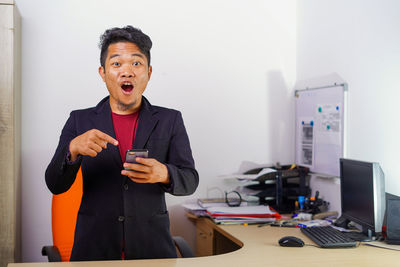 Man using mobile phone at table