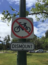 Low angle view of road sign against sky