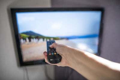 Close-up of person using mobile phone at home