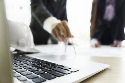 Close-up of people working on table