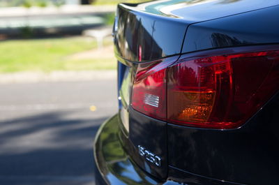 Close-up of red car on road