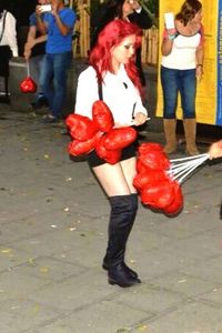 Close-up of woman holding red balloon