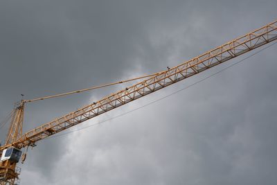 Low angle view of crane against sky