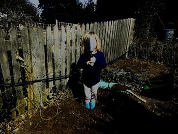 Rear view of woman standing by plants