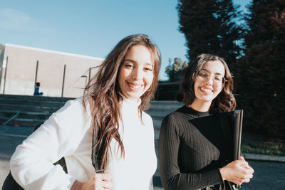 Portrait of smiling female friends standing outdoors