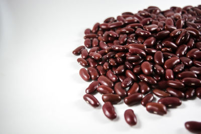 Close-up of roasted coffee beans over white background