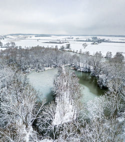 Snow covered landscape against sky